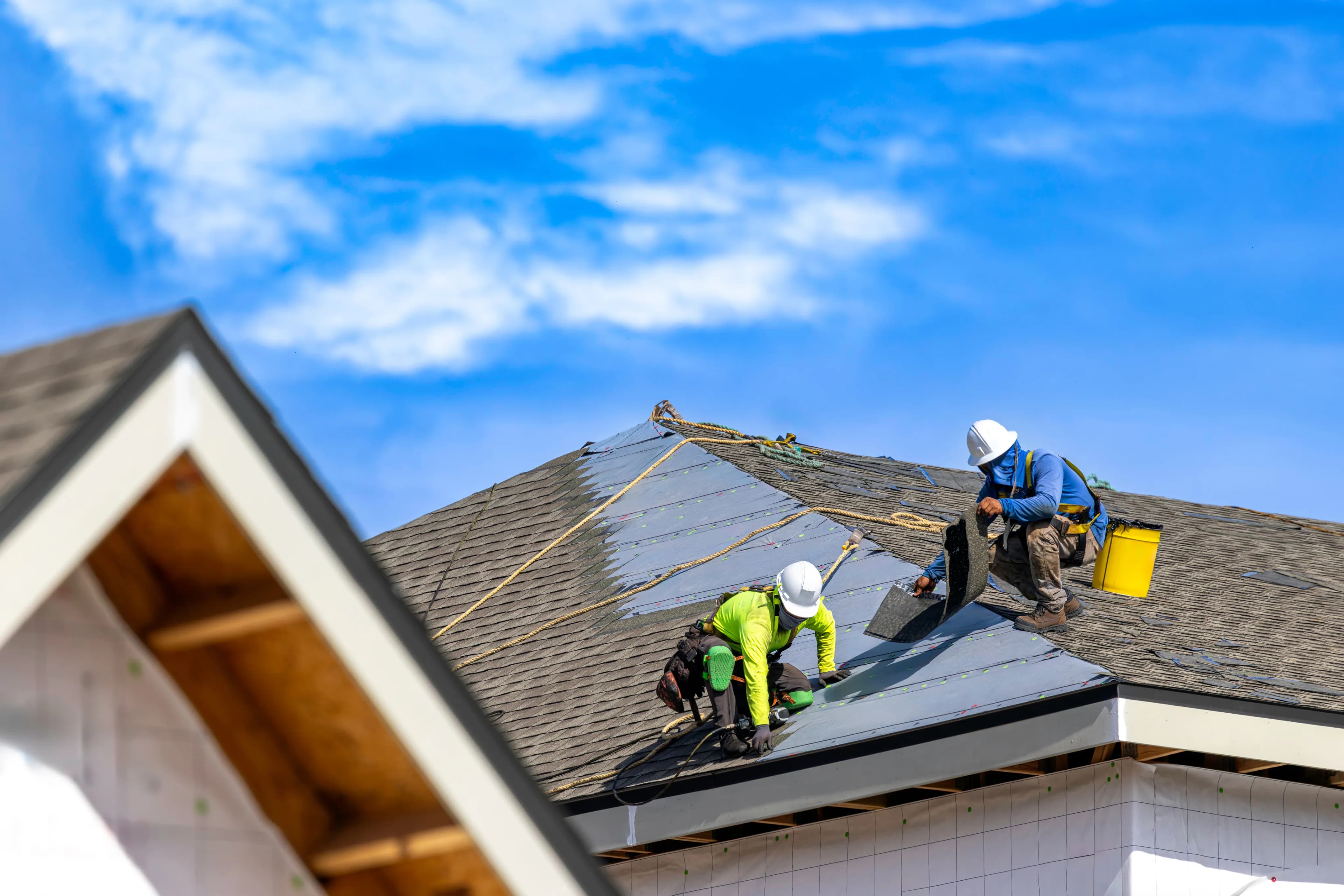EcoSmart Construct roofing specialist reviewing roof condition with South Florida homeowner