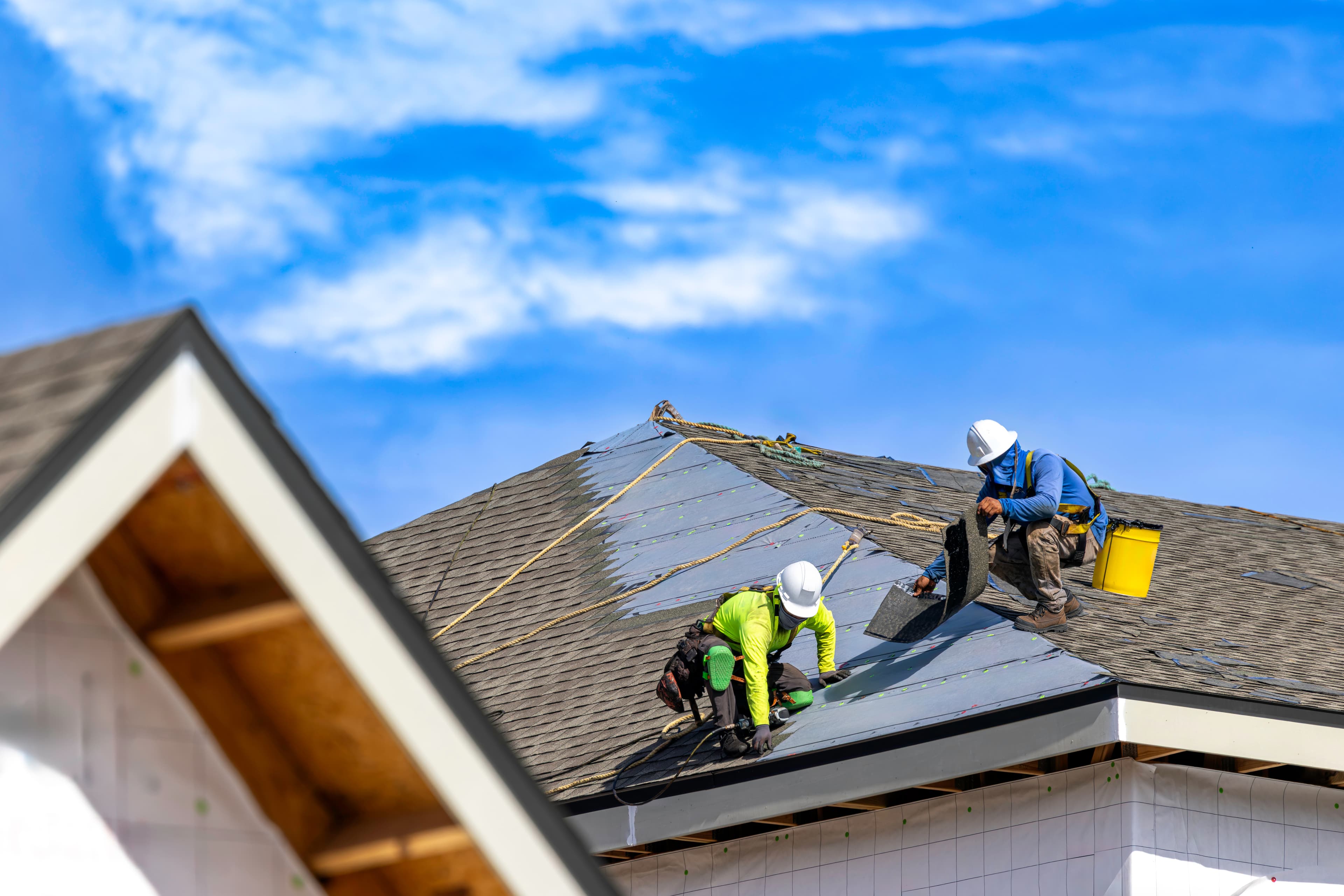 EcoSmart Construct roofing specialist reviewing roof condition with South Florida homeowner