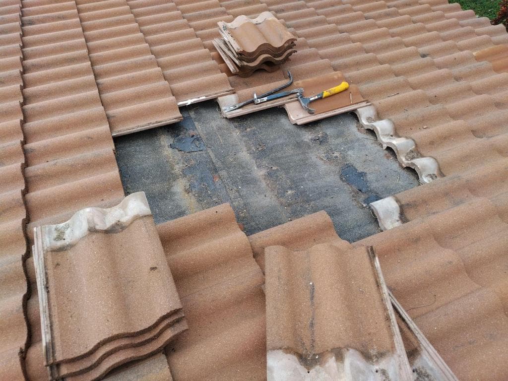 EcoSmart Construct specialist repairing roof damage on South Florida home